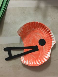 a paper plate shaped like an orange bird