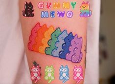 a person with tattoos on their arm and some stickers in the shape of cats