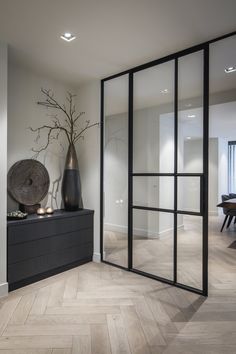 an image of a room with glass doors and vases on the table in front of it