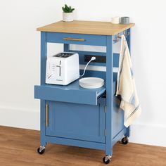 a small blue cart with a toaster on top and a towel hanging from it