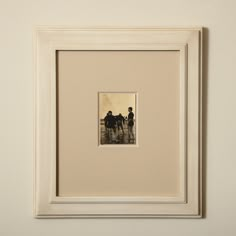 an old photo of three people riding horses in the water, framed in white frame