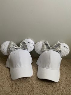 These amazing matching hats for newlyweds will make a honeymoon trip even more special! It has a black fabric and white tulle with custom iron on designs and a silver sequin fabric bow, accented with Happily Ever After ribbon!  Each pair is made to order! Can be any character, color, or theme! DM me if you would like a pair! Bride Groom Disney Ears, Disney Ears Bride, Mickey Ear Hat, Iron On Designs, Honeymoon Trip, Matching Hats, Sequin Bow, White Tulle, Ear Hats