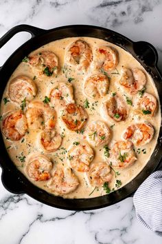 a cast iron skillet filled with shrimp and cheese