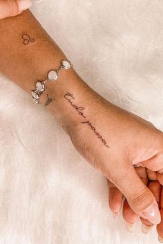 a woman's arm with a tattoo on it that says, love is in the air