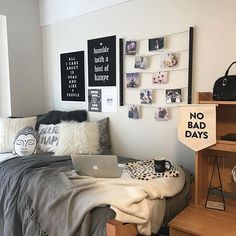 a bed room with a laptop computer on top of it next to a desk and shelves