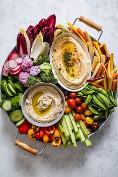 a platter filled with vegetables and dip