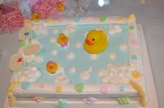 a baby shower cake with a rubber ducky in the bathtub and bubbles on it