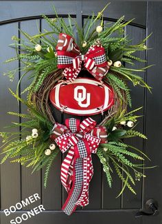 a wreath with the letter u hanging on a door