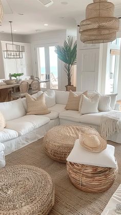 a living room filled with white furniture and lots of pillows on top of it's couches