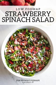 a white bowl filled with spinach salad on top of a table