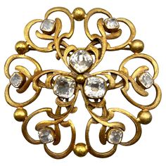 A very nice Joseff of Hollywood signature round open work Russian gold and cushion cut crystal brooch circa 1940's. Joseff of Hollywood was a jewelry firm founded by Eugene Joseff. The firm was particularly noted for creating costume jewelry for many of the biggest films and movie stars of the 1930s and 1940s, including Shirley Temple in The Little Princess, Vivien Leigh in Gone with the Wind and Elizabeth Taylor in Cleopatra. Broche Chanel, Hollywood Jewelry, Vivien Leigh, Shirley Temple, E 40, Crystal Brooch, Gone With The Wind, Gold Gold, Elizabeth Taylor