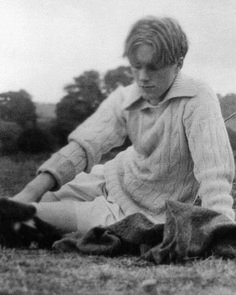 a woman sitting on the ground with her legs crossed