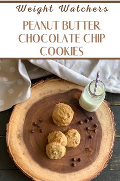 peanut butter chocolate chip cookies on a wooden plate with a glass of milk next to it