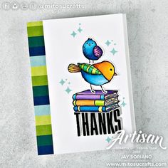 a card with a bird sitting on top of books and the words thanks written in black ink