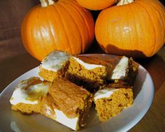 several pieces of cake on a plate with pumpkins in the background