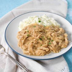 a white plate topped with meat and gravy