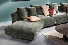 a large sectional couch with many pillows on it