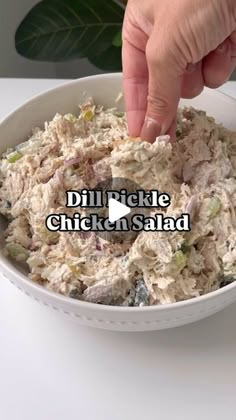 someone is dipping their hand into a bowl of chicken salad with the words dill pickle chicken salad