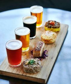 a wooden tray topped with different types of food and drinks