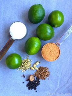 limes, spices and seasonings on a blue background