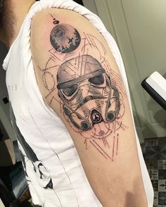 a man's arm with a star wars tattoo on it, including a helmet