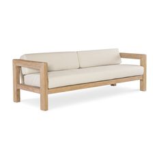 a wooden couch with white cushions on it's back end and arms, against a white background