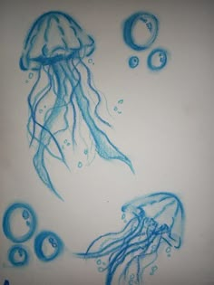 a drawing of jellyfish and bubbles on a white paper with blue water drops around it