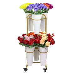 three tiered plant stand with flowers on wheels