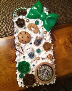 a starbucks cup holder made out of coffee beans, cookies, and other assorted items