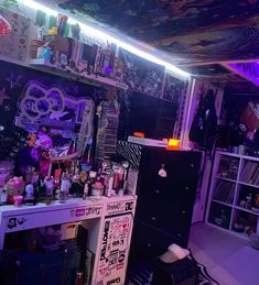 a room filled with lots of clutter and decor on the walls, including a neon light