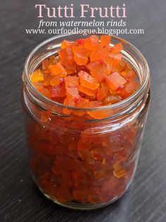 a glass jar filled with lots of food on top of a table