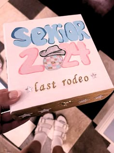 someone holding up a box with the words sexor 24 last rodeo written on it