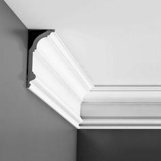 a black and white photo of the corner of a ceiling