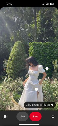 a woman in a white dress posing for the camera