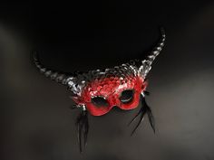 Step into a world of fantasy in a dark mythical beauty inspired long horn masquerade mask. This red/black mask is designed to make you the center of attention at any masquerade ball or Halloween party! Age Group/Gender - Adult/Women Size/Type - One size fits all adults Mask Color - Red/Black Mask Material - Polyresin Accent Material - Paint Special Features - Feathers Red Masks And Prosthetics For Costume Party And Carnival, Red Fantasy Mask For Carnival, Red Fantasy Masks And Prosthetics For Carnival, Fantasy Red Masks And Prosthetics For Carnival, Red Fantasy Masquerade Mask For Costume, Red Fantasy Masquerade Mask For Costume Party, Red Masquerade Mask For Halloween Costume, Red Masquerade Mask For Halloween, Red Fantasy Style Masquerade Mask