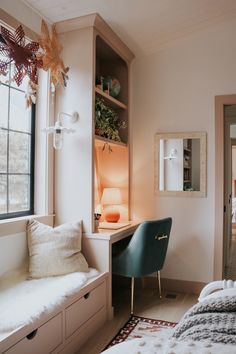 a bedroom with a bed, desk and chair next to a window in the room