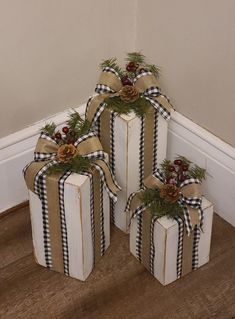 three wrapped gift boxes sitting on the floor