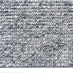 a gray and white rug with small squares on it