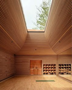 an empty room with wooden walls and flooring is seen in this image from the inside