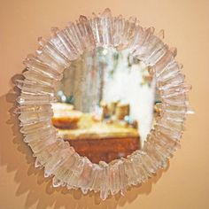 a round mirror hanging on the wall