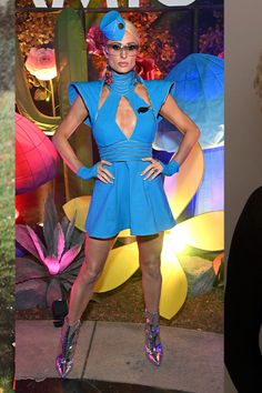 a woman in a blue dress posing for the camera next to a photo of herself