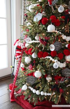 a christmas tree decorated with red, white and black ornaments