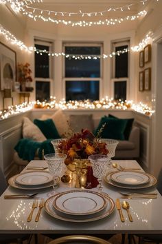 a dining room table is set with plates and place settings for two people to eat