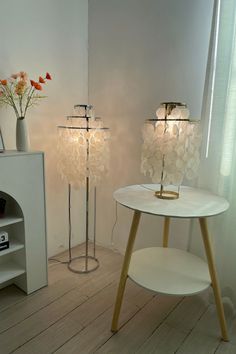 two white lamps sitting next to each other in a room