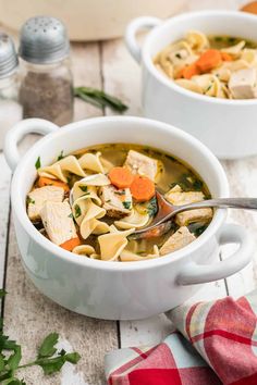 two white bowls filled with chicken noodle soup