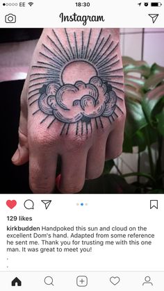 a person's hand with a tattoo on it and the sun in the middle