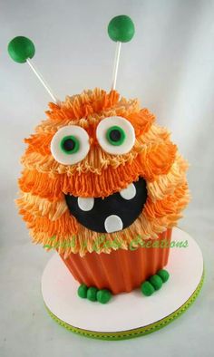 a cupcake decorated with orange and green icing