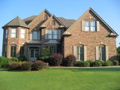 a large brick house with lots of windows