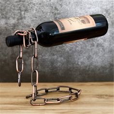 a wine bottle is chained to a metal stand