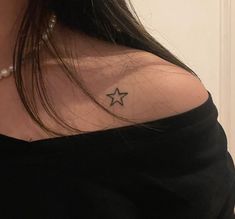 a woman with a star tattoo on her shoulder